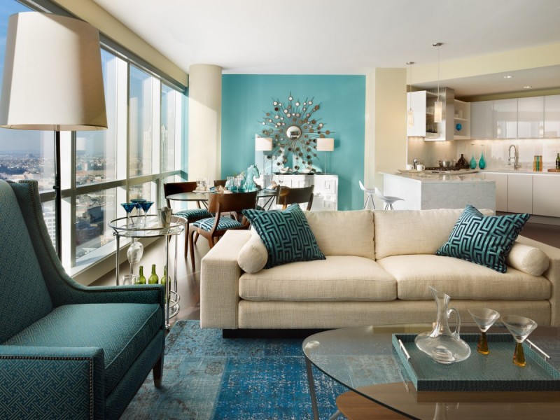 This modern and elegant living room uses different shades of aqua paired with black and creme for a gorgeous combination