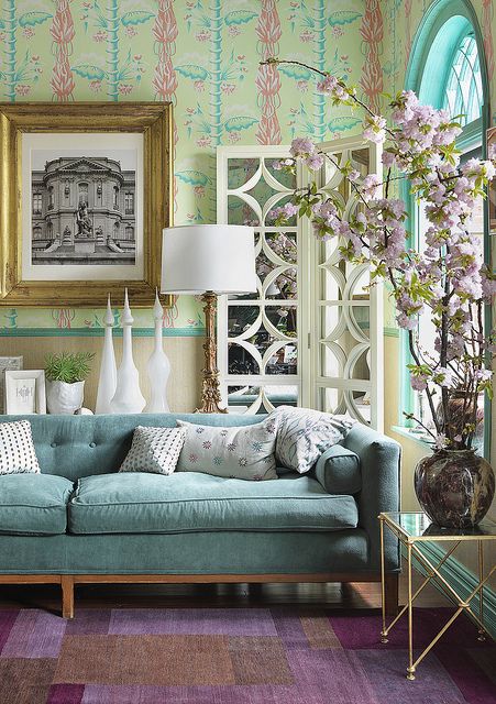 The centerpiece of this room is the gorgeous aqua couch, but other shade of aqua and sea green complement each other