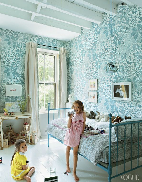 The floral aqua wallpaper in this kids room is fun and bright