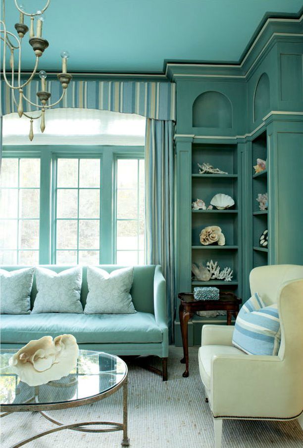 This living room as a coastal theme with all-aqua decor and sea shells everywhere