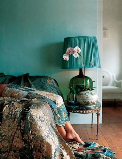 The aqua colored wall pairs perfectly with the dark silk floral bedding