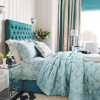 The bed and aqua linens are the focus of this room, but the slits of aqua in the curtains is a lovely touch