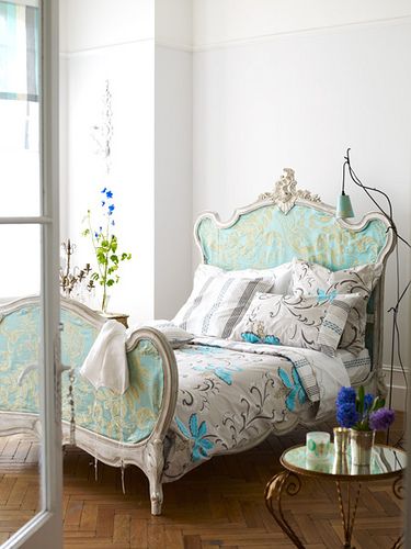 This victorian style headboard has aqua and gold fabric