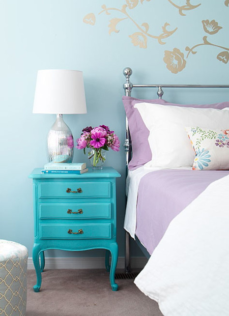this adorable aqua night stand pairs perfectly with the pops of purple in the bedroom