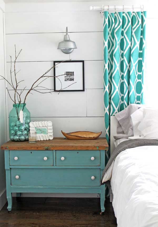 From the modern curtains to the vintage bedside table, this is a perfect example of aqua decor