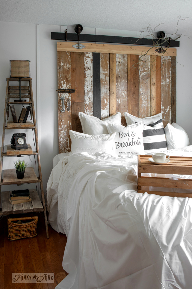This unique wooden headboard compliments the rustic decor of this bedroom.