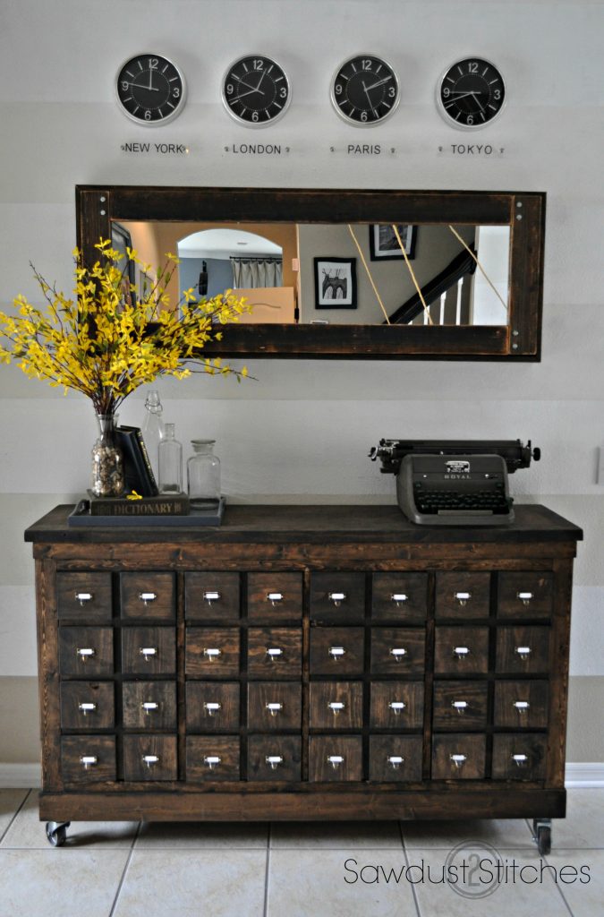 The dark stained table compliments the wood mirror on the wall. 