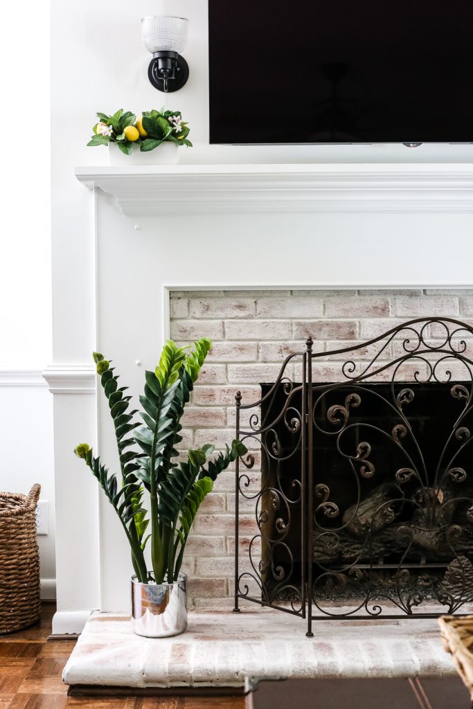 This repurposed brick on this fireplace compliment the wooden white mantel. 