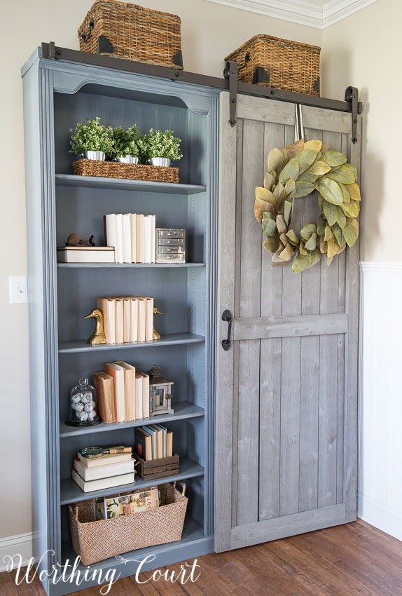 These shelves with a sliding door are functional and farmhouse chic. 