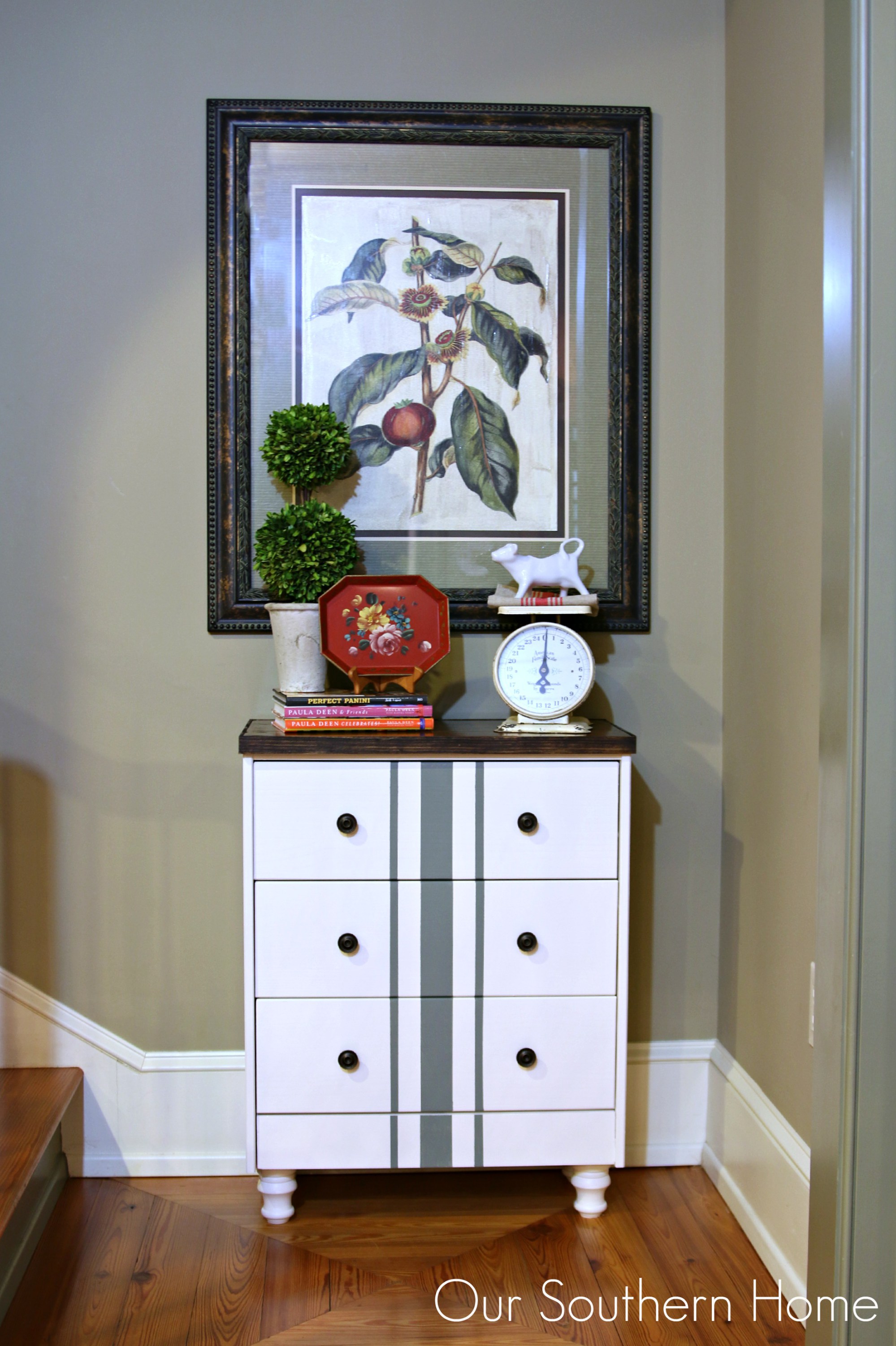 This farmhouse style chest painted white with a stripe accent is also modern. 