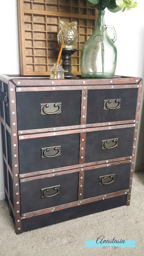 This refinished chest with a wood border pairs well with the neutral walls.