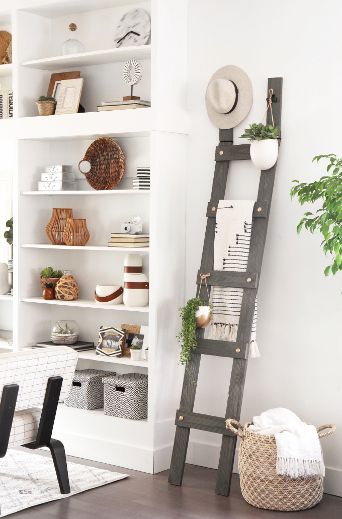 Farmhouse home decor is eclectic and simple, like these bookshelves and ladder display
