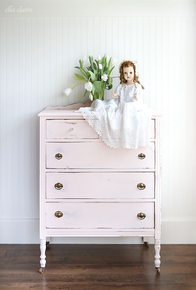 This vintage blush dresser pops against the dark stained wood floors.