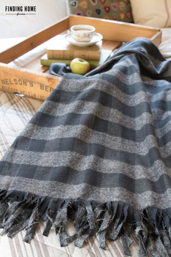 This cozy patched blanket pairs well with the wooden table tray. 