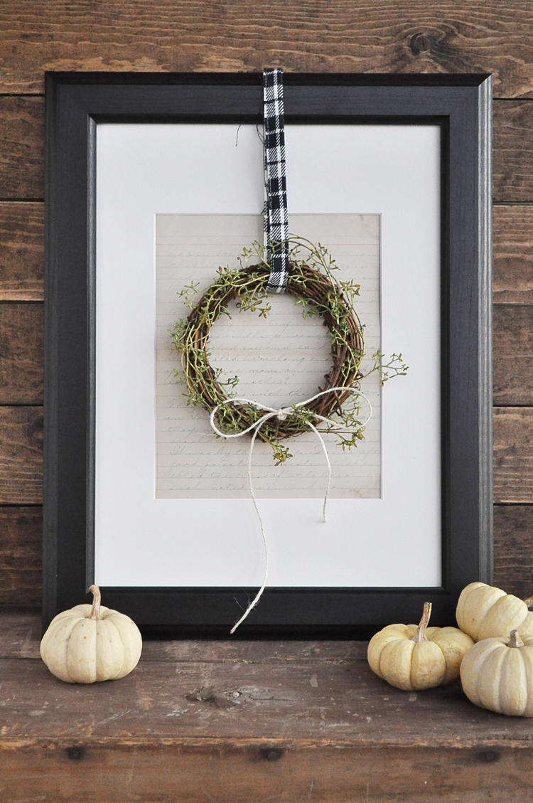 This mini hanging wreath paired with a picture frame is festive for the fall season.