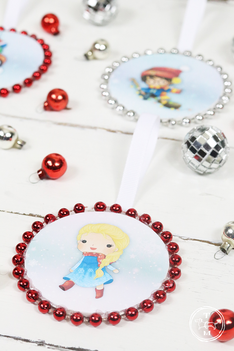These DIY Dollar Store Christmas Ornaments with Free Printables are Magical. Come and join Harry Potter and Friends, Spiderman and Friend, The Star Wars Gang and the Pretty Princesses!