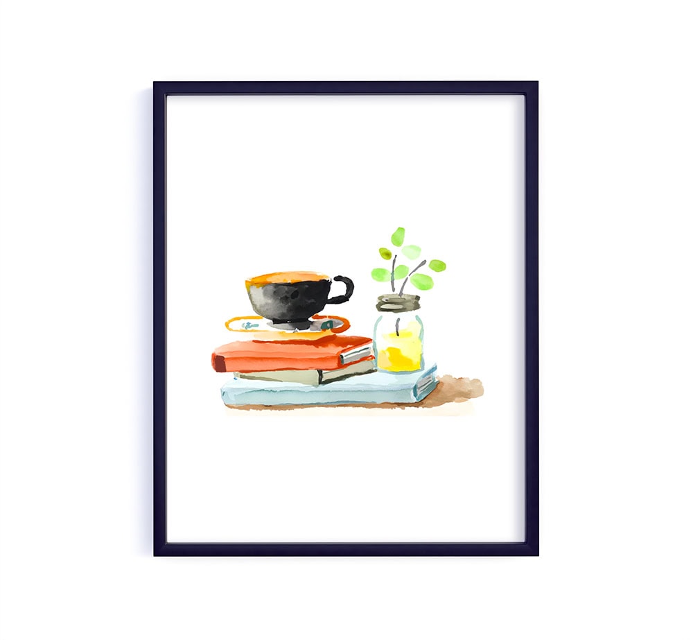 A sweet little vignette with a cup of coffee resting on a stack of books, paired with a tiny jar and greenery. It captures that peaceful slow moment… perfect for a reading nook or quiet corner.